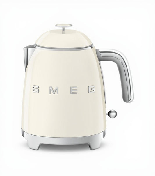 Cream-colored kettle with silver handle and 'SMEG' branding on a white background